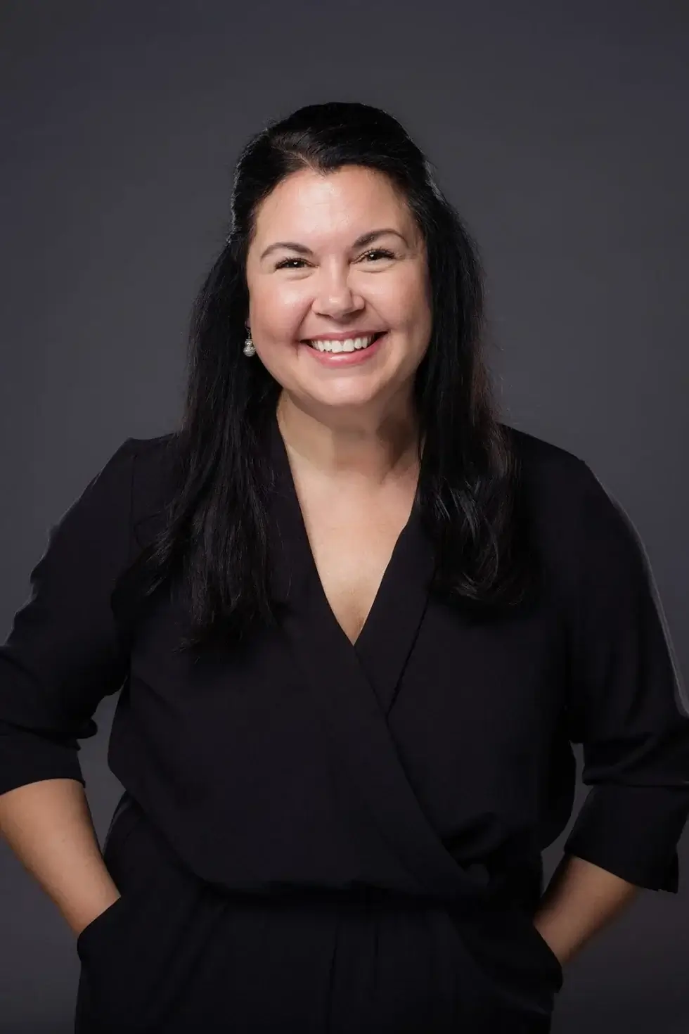 Sik_Pics_COMM_StudioDance-38 a woman keeping her hands in the pockets and posing for a picture with smile